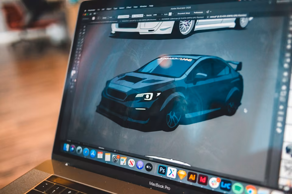 Illustration d’une voiture de sport ouverte dans un logiciel de création graphique sur un portable.